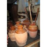A collection of five terracotta single handled baluster jugs, together with a terracotta two tone