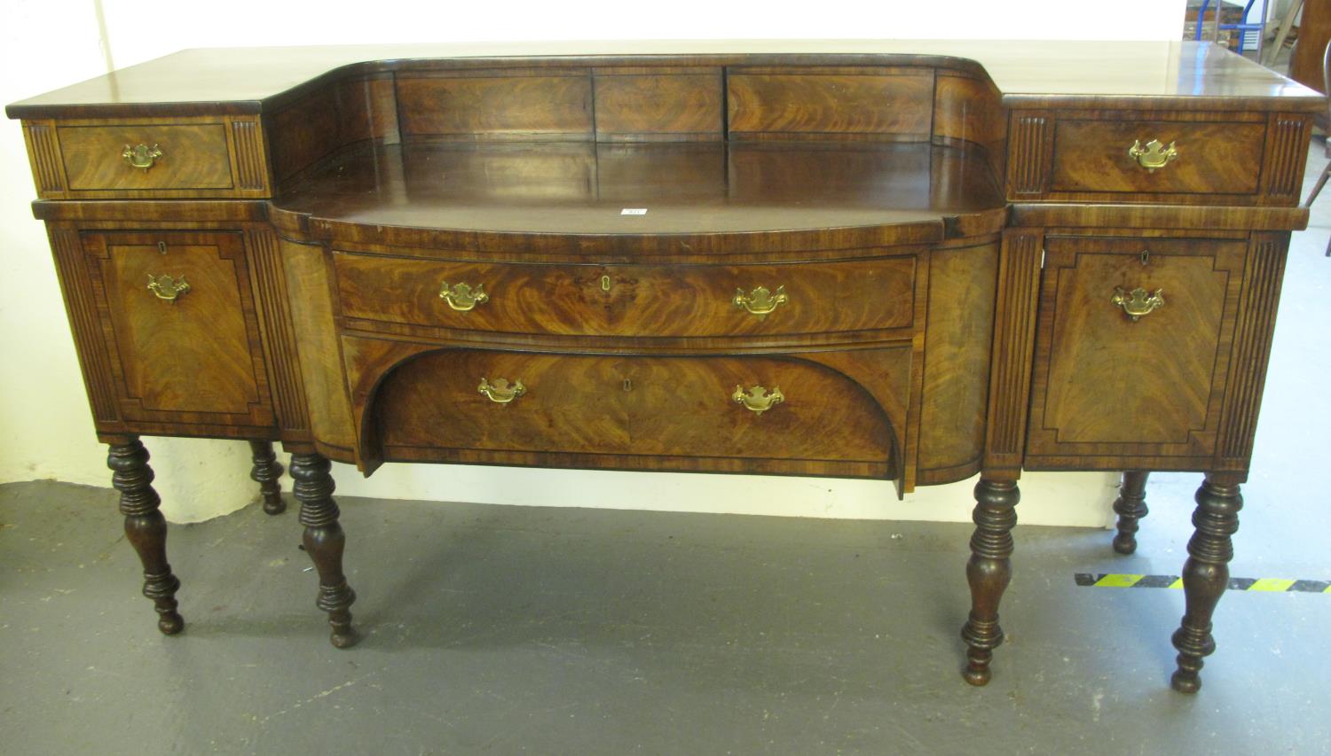 Victorian Scottish mahogany break front sideboard, having raised back with two blind cupboards