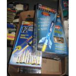 Two Estes model rocket launch sets in original boxes, together with another Estes rocket launcher in