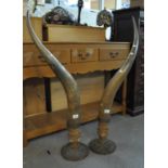 Pair of large bulls horns (possibly Oxen) on Indian design metal base with brass stud work. (B.P.