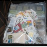 Box with all world selection of stamps in albums and covers. G.B. presentation packs and on paper