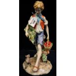 Italian pottery study of a young boy with basket of flowers and apples on naturalistic base with