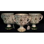 A pair of the Caverswall china Christmas two handled goblets dated 1980 and 1981, limited