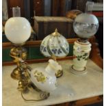 Two early 20th century double oil burner lamps, one with opaline glass reservoir, together with a