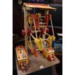 Wooden toy model of a ferris wheel with painted and detailed passengers on rectangular base. 62.