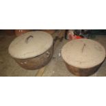 Two large similar circular cast iron lidded two handled pans. (B.P. 21% + VAT)