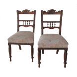 Carved walnut side chairs.