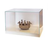 A bronze vessel / boat, in a glass display box on a white plinth. The boat 22X14cm, the glass box