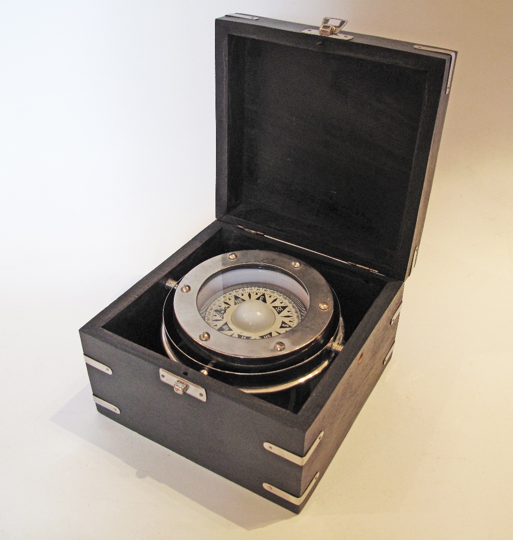 A Compass in a black wooden box. The box H10cm, 15X15cm, the compass glass W7cm.