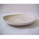 A Modern ceramic dish in off white clay by Rina Menardi W60cm.