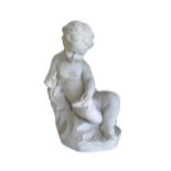 Garden Statuary: A reconstituted marble figure of a young seated scribe, modelled quill and paper in