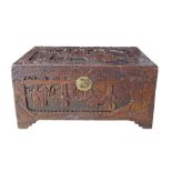 A Chinese carved camphor wood chest / trunk, with a brass clasp to the front. The chest is raised on