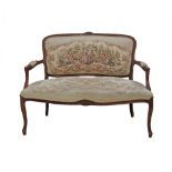 A carved wood Louis XV style two seater sofa, upholstered in tapestry style fabric. Early 20th