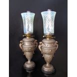 A pair of gilt cast metal / pewter oil lamps with green vaseline opalescent flaring glass shades and