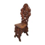 An Italian Renaissance Revival carved walnut Sgabello hall chair, c19th century, the back carved