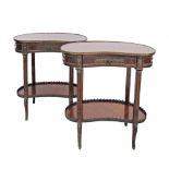 A French Transition style pair of kidney shaped two tier mahogany side tables, the tops decorated