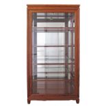 A Chinese yellow rosewood display cabinet, with mirror back, integrated spotlight, three doors and