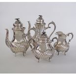 An antique silver tea set probably Turkish work, comprising a tea pot, a coffee pot H24cm, a sugar