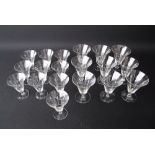 A collection of vintage hand-engraved footed wine glasses, trumpet shaped, comprising ten small