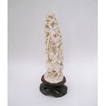 An antique Chinese ivory tusk carving depicting warrior figures on horse among trees on wooden