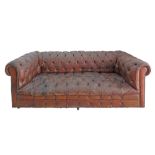 An English Chesterfield three seater brown leather sofa in need of restoration. W215cm, D90cm,