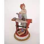 A vintage Capodimonte Porcelain figure of a lady ironing clothes by Sandro Maggioni. H23cm.