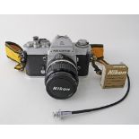 Nikon film camera EL Nikkormat no 5445516 together with a Nikon Nikkor 35mm F/2 AIS Manual Focus