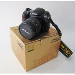 Nikon D200 Digital SLR Camera Body With MB-D200 Battery Pack together with a Nikon Nikkor 24-120mm
