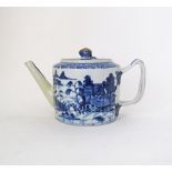 A Chinese export blue and white teapot, circa 1770, decorated with a river landscape scene with