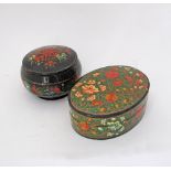 Two Russian handpainted and lacquered floral boxes, W17cm and Diam. 15cm. (2)