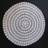 A large white crochet table cloth of a round shape, diam. 150cm.