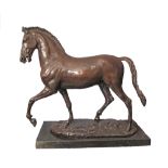 A patinated bronze figure of a prancing horse on a black marble base, late 20th / early 21st