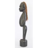 An African carved and ebonized wood tribal figure H66cm.