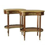 A French Transition style pair of kidney shaped two tier mahogany side tables, the tops decorated