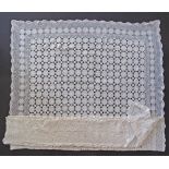 A large white crochet table cloth of a rectangular shape 150x240cm.