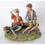 A Capodimonte porcelain figure of two boys eating grapes, late 20th/ early 21st century. H19cm,