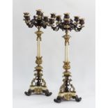 A pair of French Restoration, gilt and patinated metal mounted and white marble six light