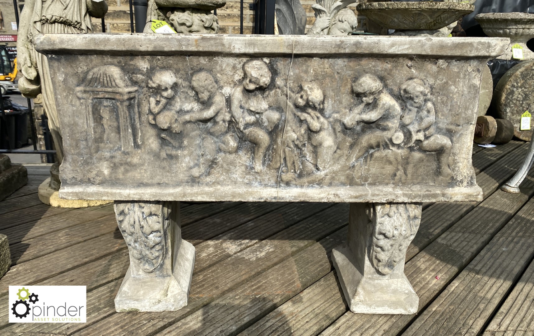 Rectangular reconstituted stone Planter standing on corbeled legs depicting putti playing, approx.