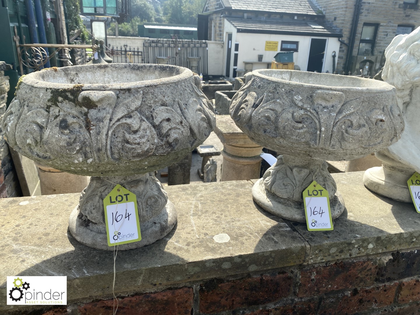 Pair of reconstituted stone Garden Urns with fleur de Lau decorations, approx. 14in high x 18in