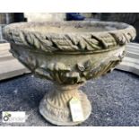 Reconstituted stone Urn depicting floral patterning.