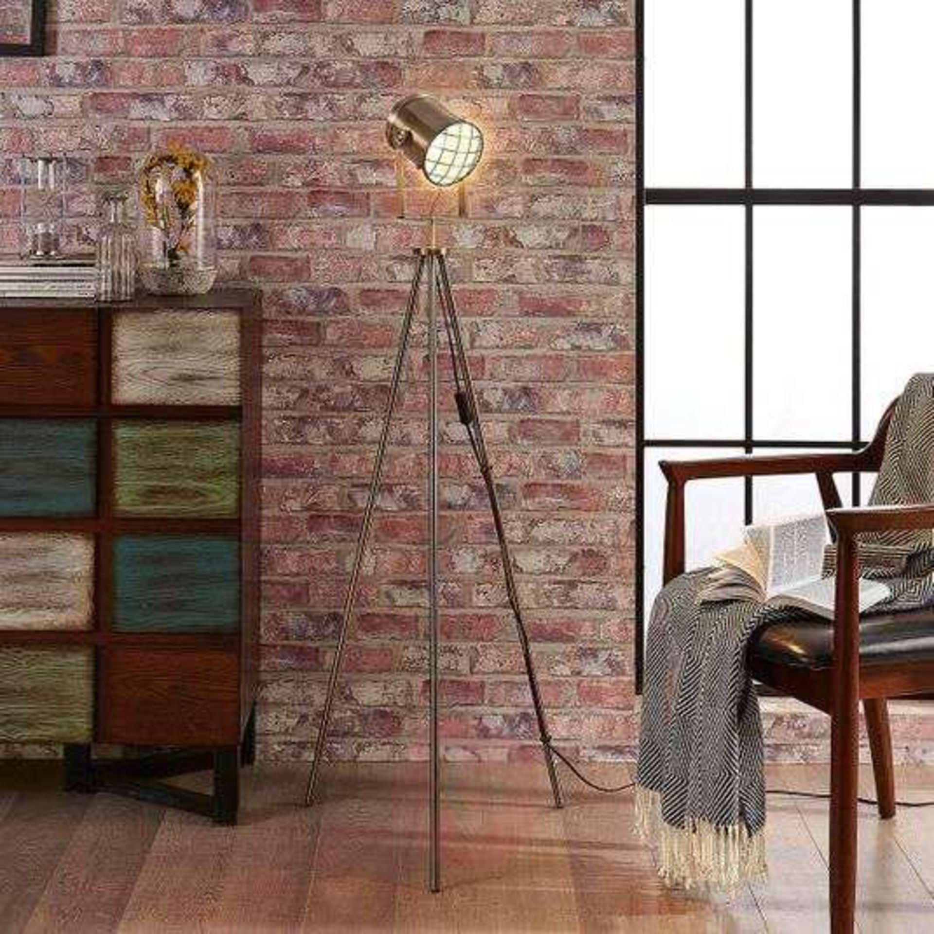 Industrial Tripod Lamp With its tripod frame, reminiscent of a tripod as used in photography. The