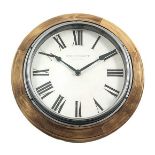 Wood Frame Wall Clock wood-edged circular wall clock features chunky black Roman numerals set