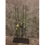 Contemporary Antique Bronze Resin Sculpture Of Two Figures Climbing A Ladder On A Matt Black Base.