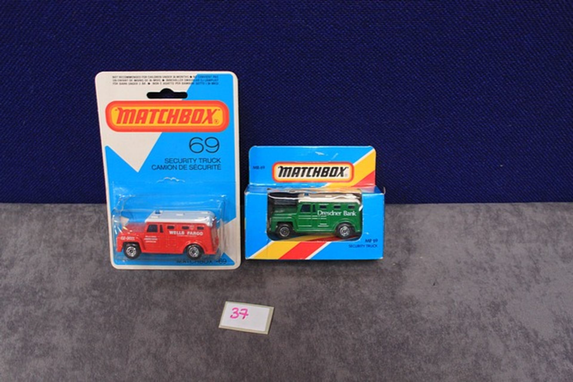 2x Matchbox Diecast Number 69 Security Trucks Comprising Of; Red Wells Fargo On Card & Green