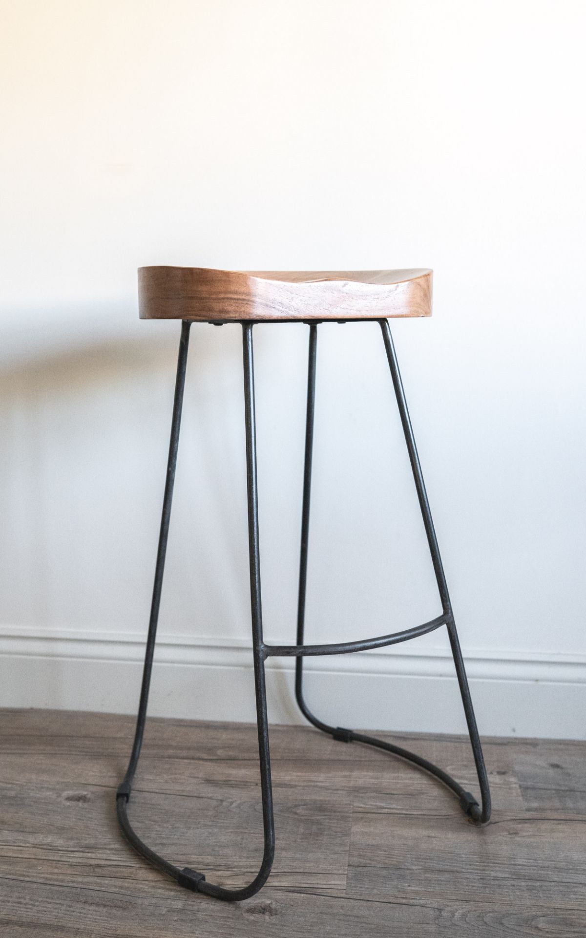 Tall Dark Wood and Iron Stool: A gorgeous high bar stool with an ergonomic seat.