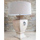 Wooden Lamp: A large, beautifully carved wooden lamp finished in a light natural stain.