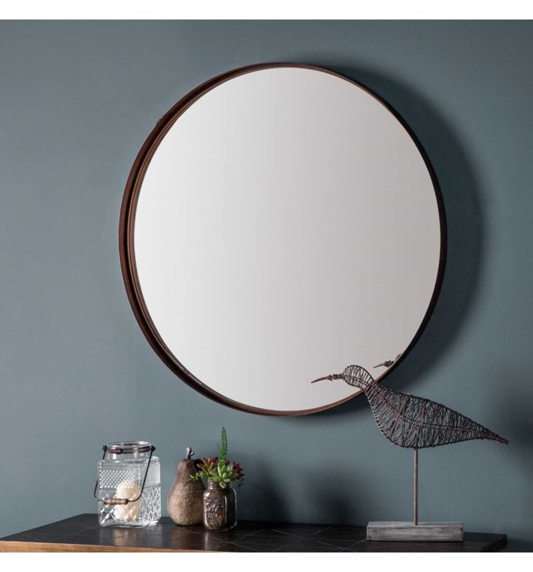 Greystoke 830mm Sleek and stylish round metal framed mirror in an aged bronze finish.