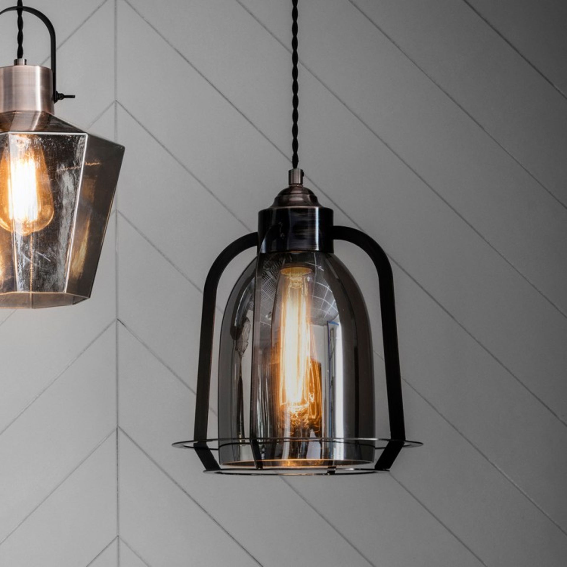 Aykley Pendant Light With a glass shade and industrial style metal surround this pendant light