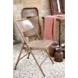 A traditional folding Indian single seater chair cast from treated iron with a brown coating Perfect