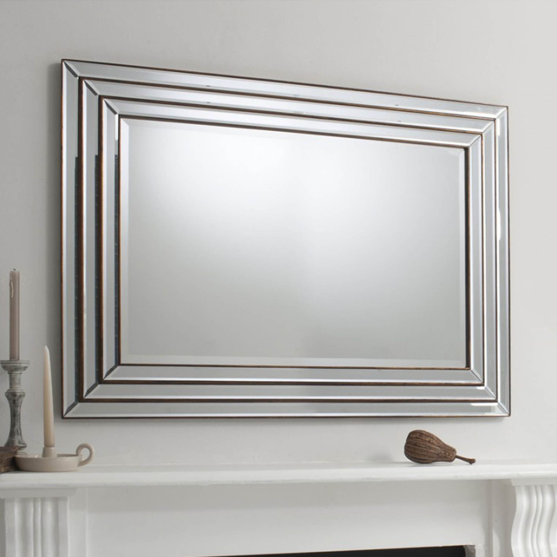 Chamberley Mirror A stunning, triple step, bevelled mirror frame with a warm bronze gleaming through